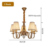 chandelier bronze classique suspension lumière abat jours tissu texturé courbes salle manger
