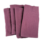 Un ensemble de serviettes de bain en tissu doux et texturé de couleur bordeaux.