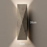 applique murale moderne pierre gris clair aspect granitique led chambre entrée étude interrupteur bouton