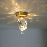 lampe suspendue or transparent cristal facettes géométriques moderne élégante tringles câbles