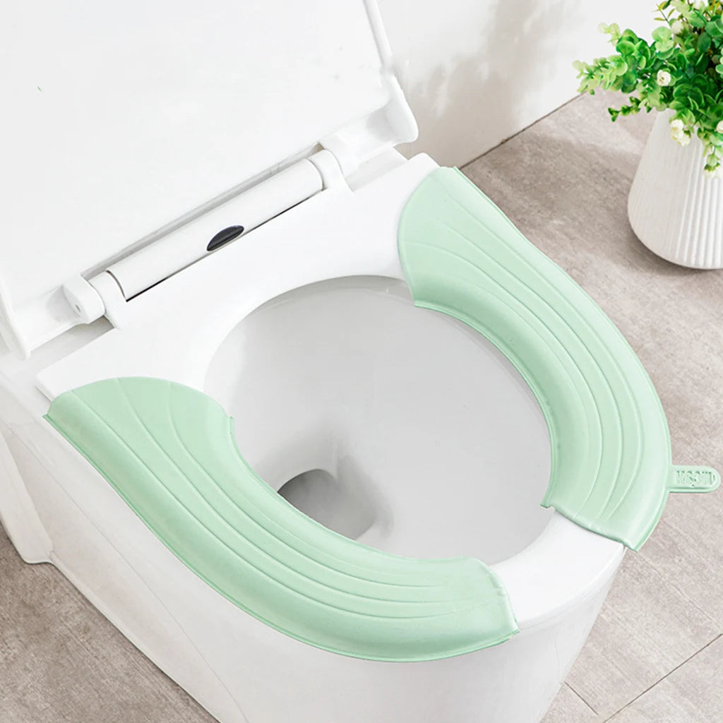 siège toilette pliable vert clair moderne texture souple clips fixation pratique