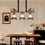 suspension lumineuse marron doré noir verre teinté métal sculpté moderne rustique chaînes noires