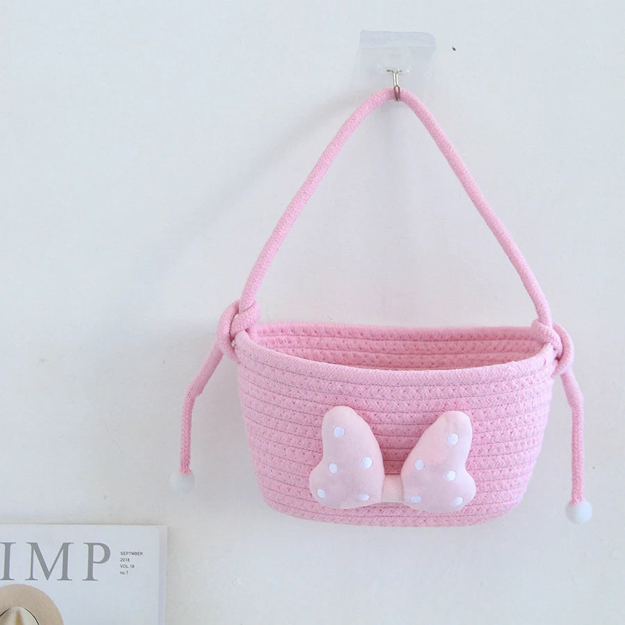 panier rangement rose blanc rayures horizontales noeud décoratif réutilisable polyestère enfantin cordelette organisation jouets