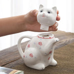 théière céramique forme chat motifs floraux tasses fleurs figurine chat blanc rouge bleu