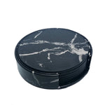 Ensemble de sous-verres ronds en marbre noir avec motifs de veines blanches.