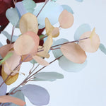bouquet artificiel feuilles ovales moderne vase transparent support doré couleurs vives exposition intérieure