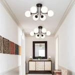 luminaire moderne or noir globes verre opaques semi suspendus métal