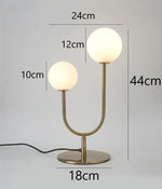 lampe table moderne or blanc sphères translucides câble noir base plate