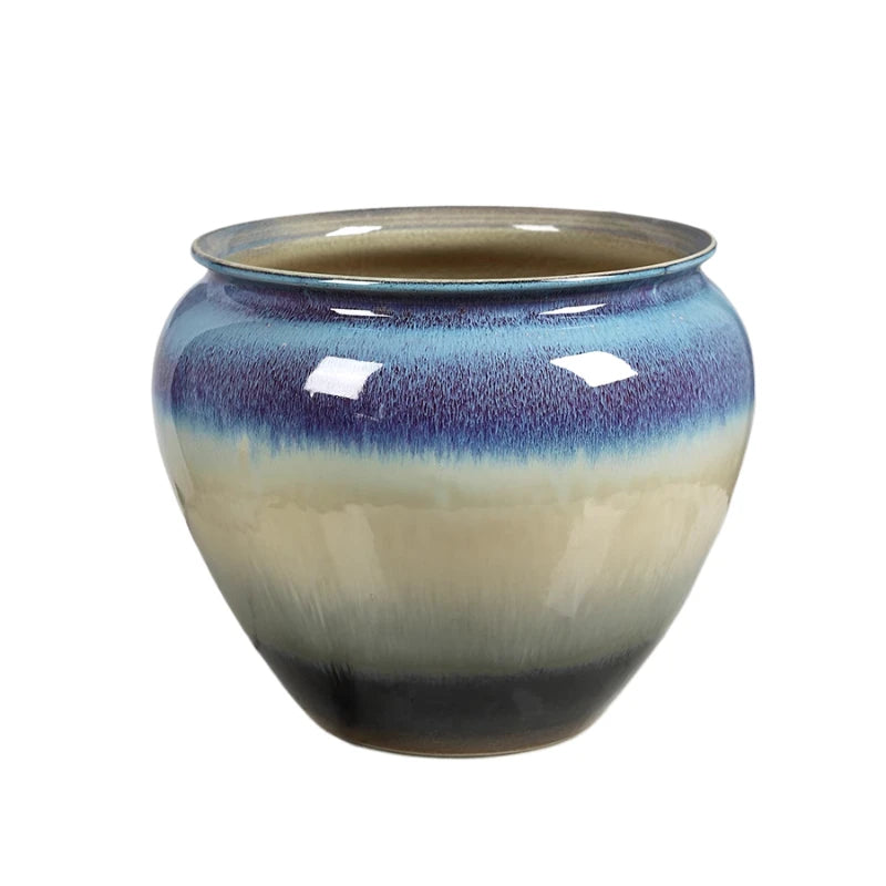 Un bol en céramique aux nuances bleu et beige, avec une texture lisse et brillante.