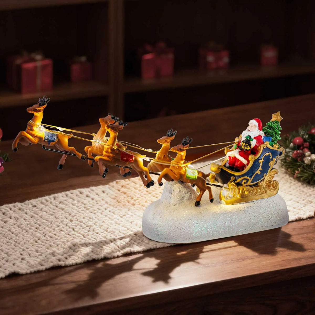 Traîneau et renne dans un village de Noël miniature