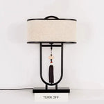 lampe table tissu texturé moderne asiatique pompon abatjour opaque métal noir