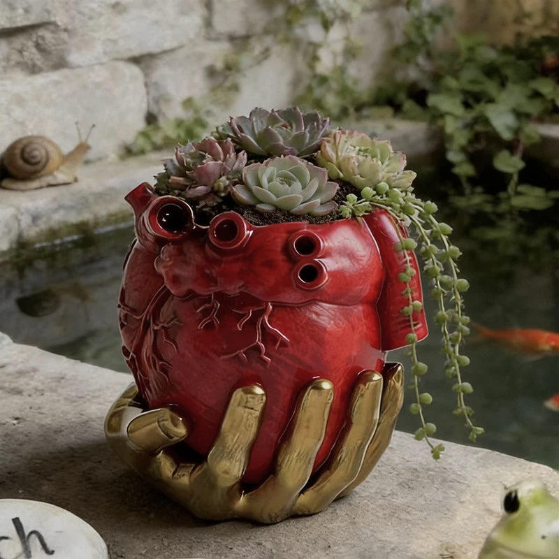 pot fleurs cœur anatomique rouge mains dorées plantes succulentes décoratives escargot poisson love speech