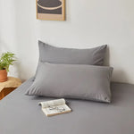 taies d'oreiller lisses polyester coton gris bleu rose blanc modernes literie décoration chambre voyage