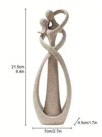 sculpture couple enlacé moderne beige clair doré rouge décoration intérieure vase branches bougies fleurs