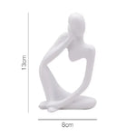 statue décorative moderne figure humaine assise couleur or noir beige.texture granuleuse surface lisseintérieur moderne