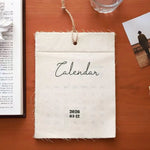 calendrier mural tissu lin beige clair minimaliste rustique pince magnétique ruban coton deco mur