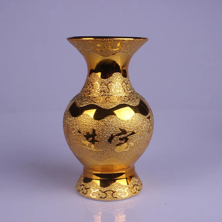 Cette image montre un vase décoratif doré avec des motifs complexes et une forme unique.