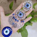 Pendentif oeil turc bleu argenté motifs géométriques artisanal protection maison