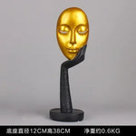 masque sculptural contemporain noir blanc doré finement sculpté base circulaire ornement salon