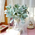 bouquet artificiel feuilles ovales vert clair gris rustique naturel vase transparent emballage brun serviette