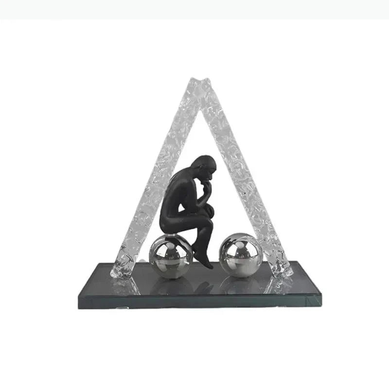 sculptures décoratives modernes homme assis sphères figures suspendues transparentes textures cristallines contemporaines