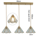suspension lumineuse verre teinté art deco or marron bleu clair motifs géométriques opacité chaînes
