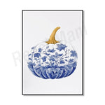 Citrouille décorative ornée de motifs bleus floraux et de dorures élégantes sur un fond blanc.