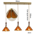 suspension lumineuse verre teinté art deco or marron bleu clair motifs géométriques opacité chaînes