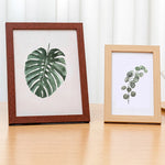 Cadre photo mural en bois 10x15 cm couleur blanc sur mur beige