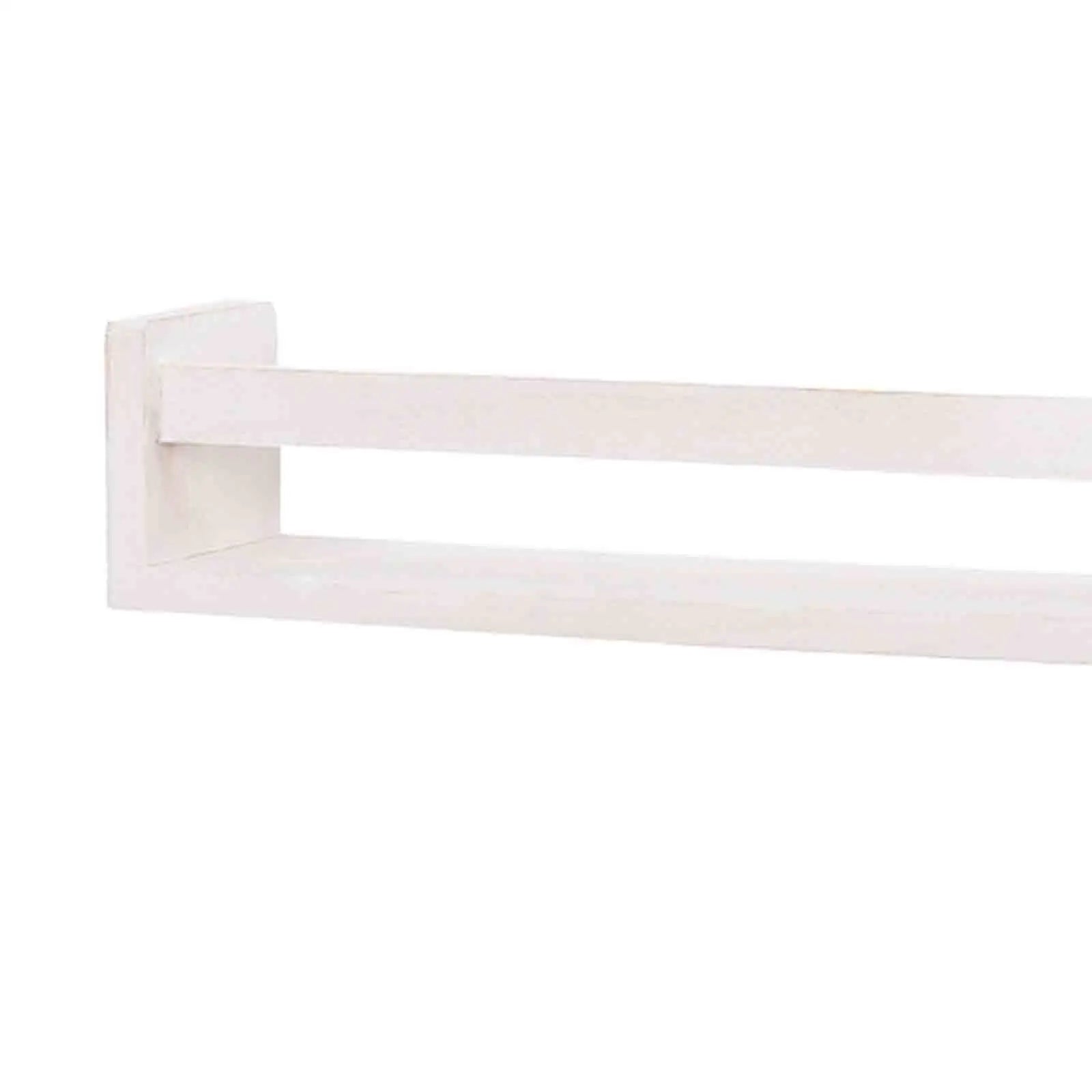 Étagère flottante utilisée comme rangement pour livres dans une chambre