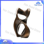 sculptures décoratives abstraites modernes or bronze marron surfaces polies aspect texturé rouille base pierre