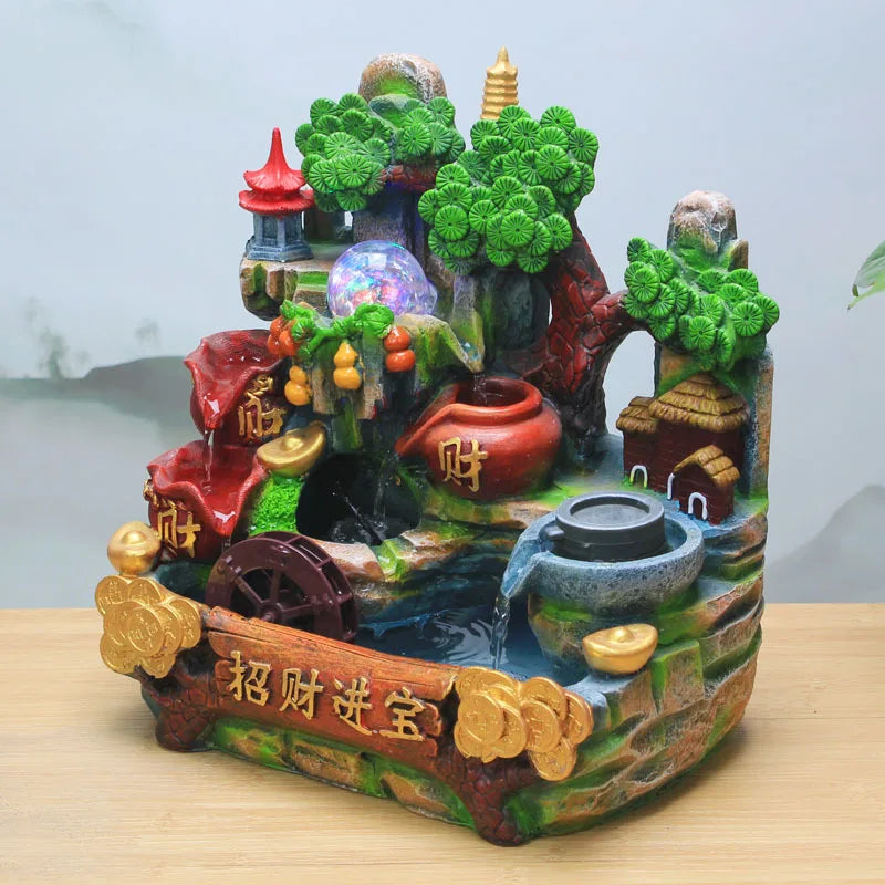 Cette image montre une statuette décorative représentant un paysage chinois fantaisiste avec des éléments traditionnels comme des pagodes, des fleurs de lotus et des pièces de monnaie, évoquant la prospérité et la bonne fortune.