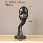 masque sculptural contemporain noir blanc doré finement sculpté base circulaire ornement salon