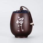 pot thé marron imprimé floral couvercle texte blanc classique traditionnel cordon boule bois épices