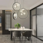 lumière suspendue moderne pendentif géométrique transparent cercles métalliques dorés chambre salon