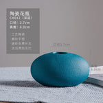 Vase en céramique turquoise de forme elliptique avec des informations détaillées sur ses dimensions et ses caractéristiques.