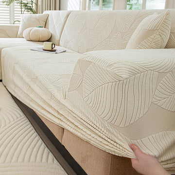 housse canapé extensible beige clair motif feuilles imprimées moderne protection meubles