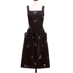 tablier cuisine noir fleurs blanches coton polyester plissé croisé dos poches classique imperméable