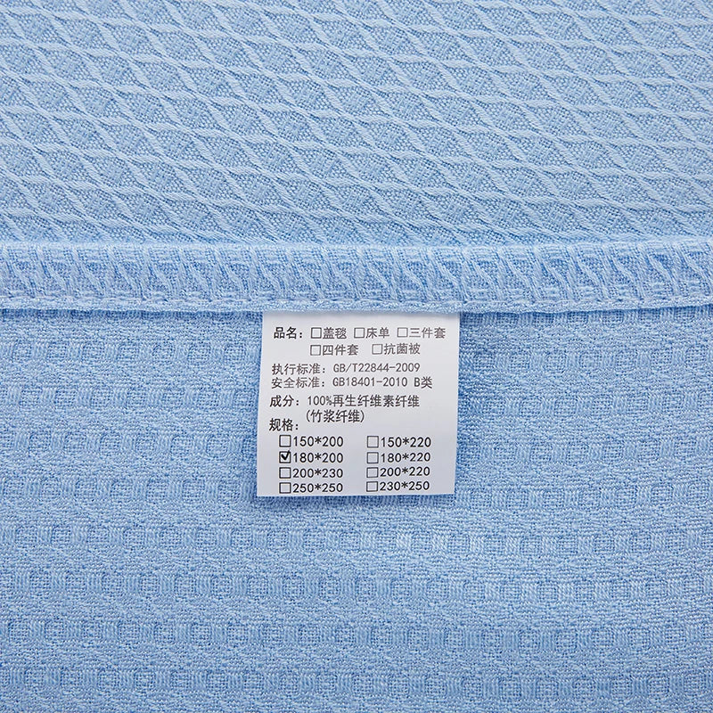 Cette image montre un motif géométrique bleu sur un textile, avec une étiquette produit indiquant des informations techniques.