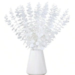 bouquet artificiel feuilles vertes naturel minimaliste ruban blanc vase blanc tapis beige ornement extérieur
