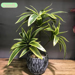 plantes artificielles feuilles striées pot texturé décoration intérieure moderne vert jaune marron gravier