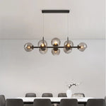 Suspension lumineuse moderne sphères transparentes dorées structure métallique noir chambre salon