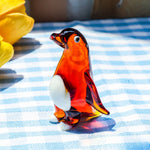 statuettes manchots transparents artisanales couleur verte orangée noire