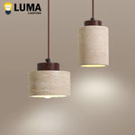 Suspension lumineuse pierre beige clair texture granulée moderne câble noir chambre salon