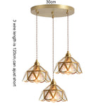 suspension lumineuse verre teinté art deco or marron bleu clair motifs géométriques opacité chaînes