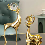 statues cerfs dorées boule cristal moderne décoration vase fleurs artificielles tableau noir