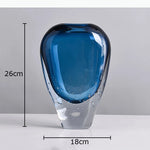 vase moderne transparent bleu foncé bulles fleurs artificielles feuilles bougie minimaliste