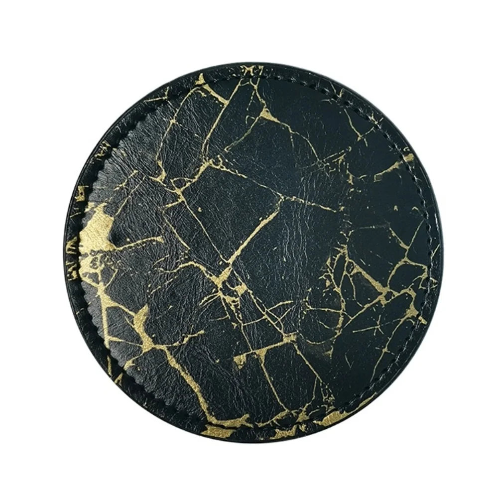 Une table ronde aux motifs de marbre noir et de veines dorées, évoquant l'élégance et la sophistication.
