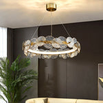 suspension lumineuse moderne dorée transparente disques circulaires texture rugueuse contemporaine élégante chaînes suspendues LED