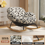 fauteuil bascule moderne beige noir orange roulettes coussin repos minimaliste salon
